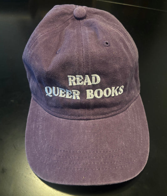 Purple "dad" hat with Read Queer Books stitched on the front in white letters